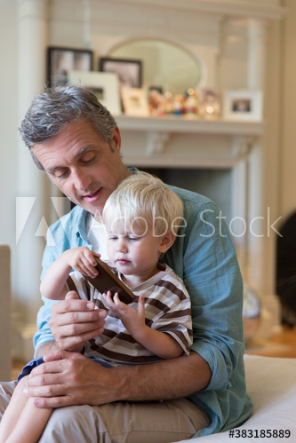 Father and son using smart phone