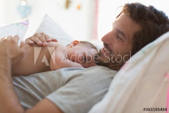 Father cuddling baby son