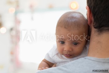 Father holding cute baby son