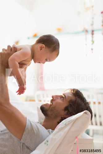 Father lifting baby son