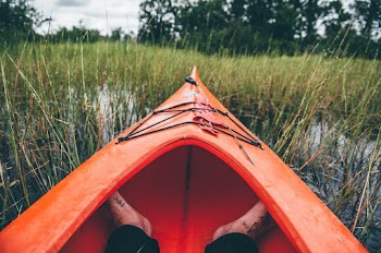 Feet on Red Kayak Boat