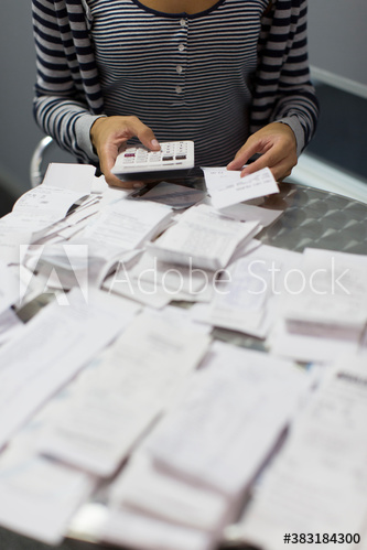 Female accountant calculating receipts in office