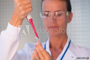 Female biochemist using pipette