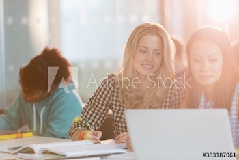 Female college students studying at laptop
