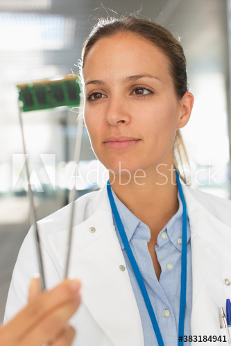 Female engineer examining computer chip