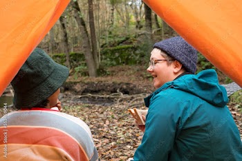 Female friends camping in forest