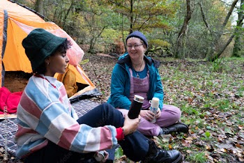 Female friends camping in forest