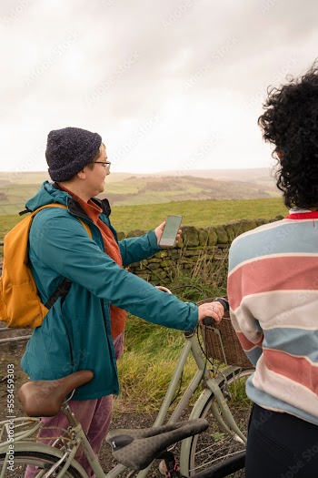 Female friends cycling on rural road