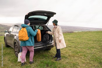 Female friends packing car for hiking trip