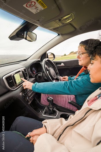 Female friends using GPS in car