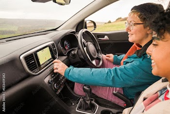 Female friends using GPS in car