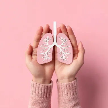 Female Hands Holding Paper Lungs on Pink Background - Lung Cancer Awareness