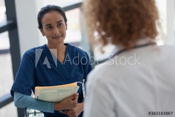 Female nurse consulting with doctor in hospital