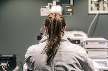 Female Scientist Looking Through Microscope