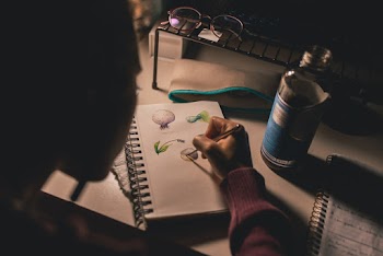Female Sketching on White Spiral Sketchbook