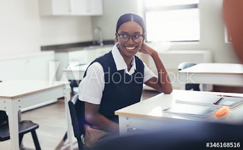 Female student sitting at desk in classroom