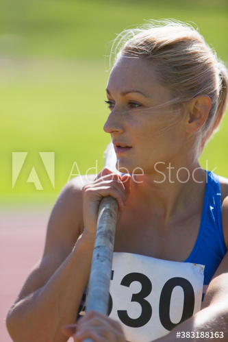 Female track and field athlete preparing to pole vault