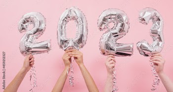 Festive balloons in from the numbers 2023 on a pink background.