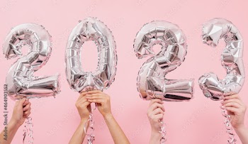 Festive balloons in from the numbers 2023 on a pink background.