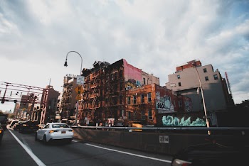 Few Cars on Road Near High-rise Buildings