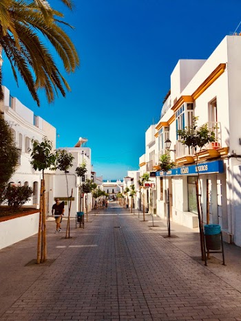 Few People Walking Near White Buildings