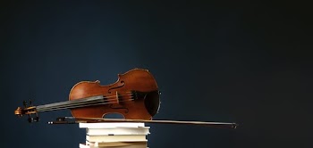 Fiddle And Bow On Stack Of Books