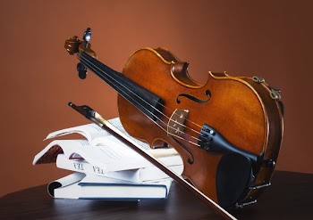 Fiddle And Bow Rest On Stack Of Books