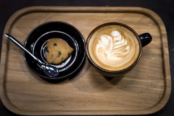 Filled Brown Mug Beside Heart Pastry on Brown Wooden Tray