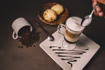 Filled Footed Glass Cup on Plate