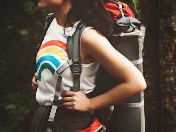 filtered photography of woman carrying hiking backpack