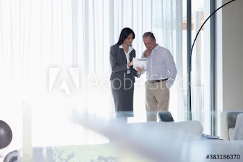 Financial advisor discussing paperwork with senior man