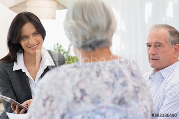 Financial advisor with digital tablet meeting with senior couple