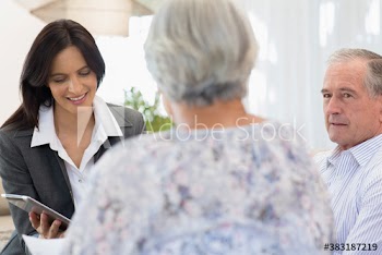 Financial advisor with digital tablet meeting with senior couple