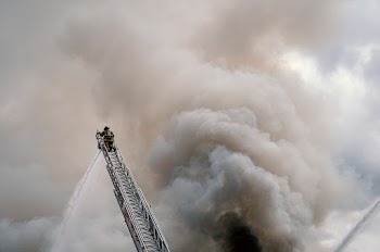 Fire Fighter At The Top Of A Ladder