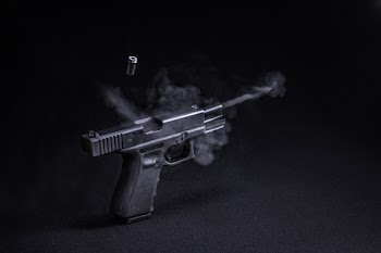 Fired Black Semi-automatic Pistol Emitting Smoke