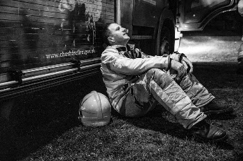 Firefighter sitting against wall, April | Free Photo - rawpixel