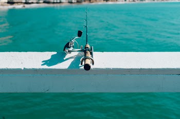 Fishing Rod on White Wooden Beam