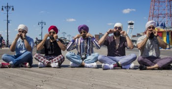 Five Men Sitting on Ground