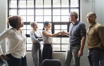 Five People Standing Near Window Inside Room