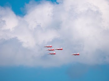 five red-and-white planes in flight