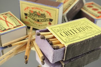 Five Safety Match Boxes on Gray Surface