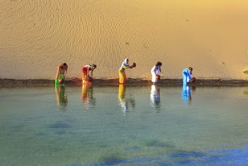 Five Women Getting Water From Body of Water