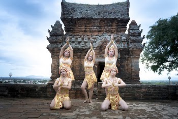Five Women in Front of Brown Building While Posing