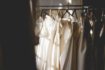 five women's white hanged gowns
