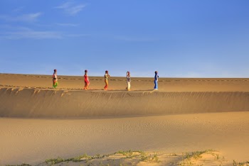 Five Women Walking On Sand