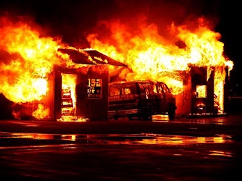 flaming house and vehicle during daytime