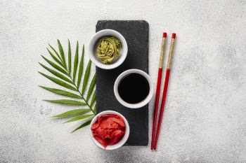 Flat lay ginger wasabi and soy sauce bowls on slate Free Photo