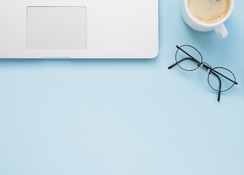 Flat lay of clean office desk with blue background Free Photo