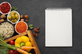 Flat lay of notebook mock-up and vegetables Free Photo