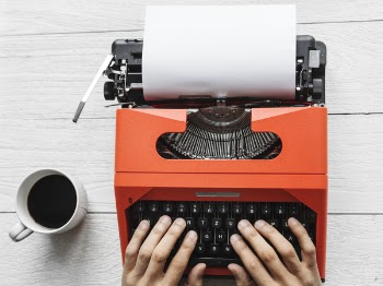 Flat-lay Photo of Hands Typing on a Typewriter
